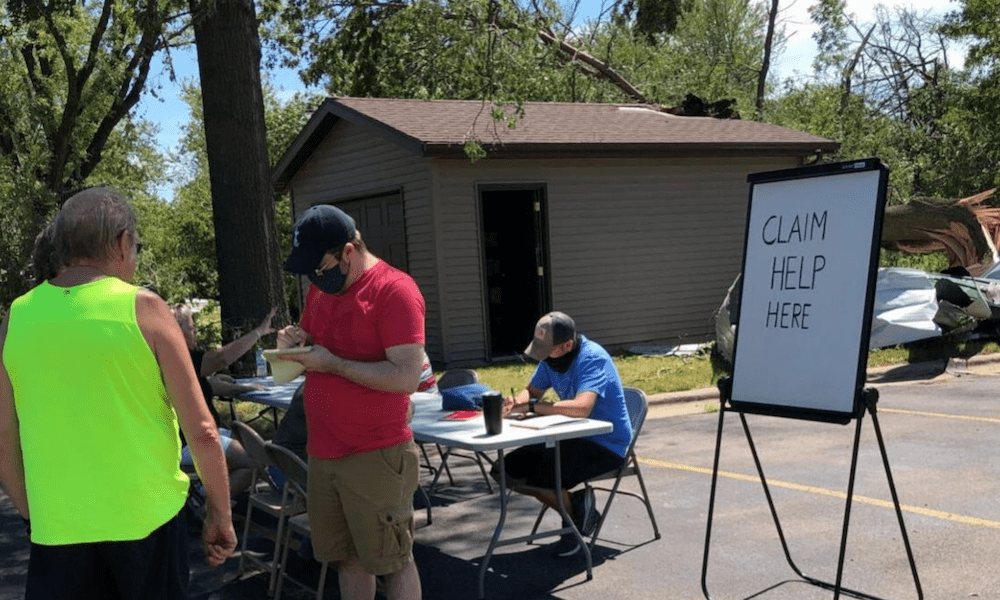 Claims Help - White Board Stating Claim Help Here With People Standing Around