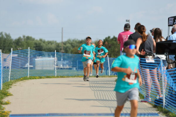 Photo of kids racing in Accel Crawfish Crawl shirts