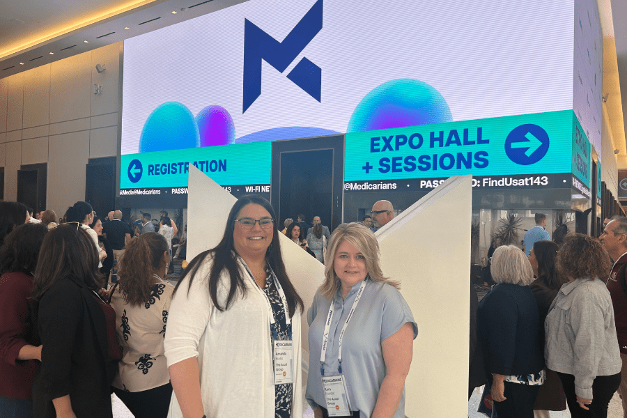 Amanda Burks and Kara Roeder in front of Medicarians display at convention in Las Vegas, NV