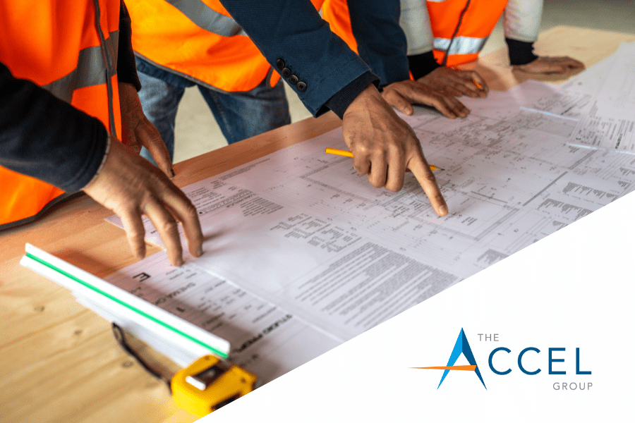 The Accel Group logo with construction blueprints and workers with orange vests