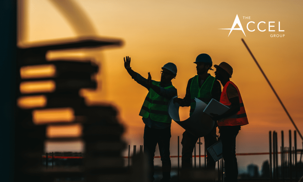A silhouette of construciton workers with The Accel Group logo in corner